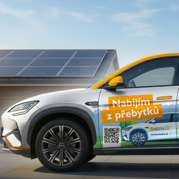 Electric car with orange promotional wrap parked in front of solar panels, advertising Nabíjím z přebytků with a QR code on the door.